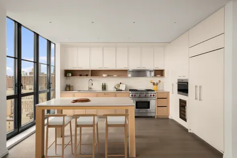 a kitchen with stainless steel appliances granite countertop a stove a refrigerator and a refrigerator