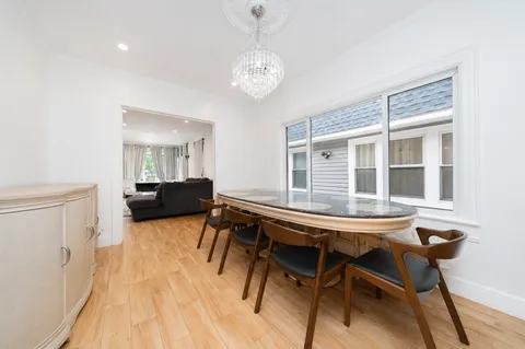 a view of a dining room with furniture and a chandelier