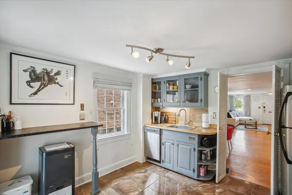 a living room with furniture a window and wooden floor