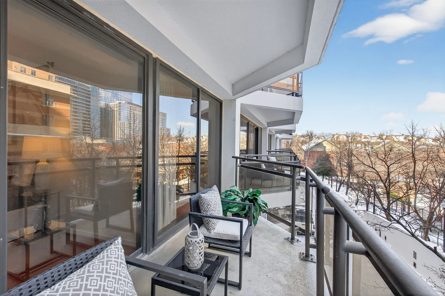 a balcony with furniture and a potted plant