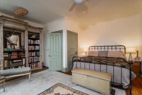 a bedroom with furniture and a book shelf