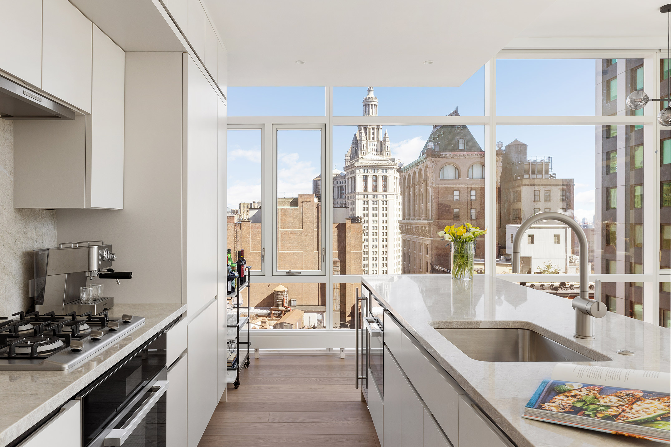 5 Beekman Street, Unit 21B Manhattan, NY 10038 - Photo 2 of 23 a kitchen with stainless steel appliances kitchen island granite countertop a sink and cabinets