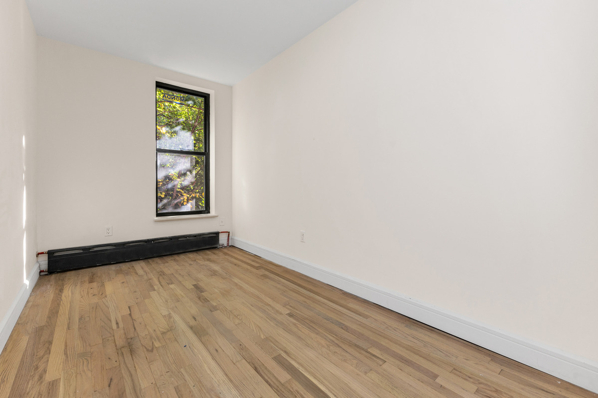 574 Gates Avenue Brooklyn, NY 11221 - Photo 6 of 16 an empty room with windows