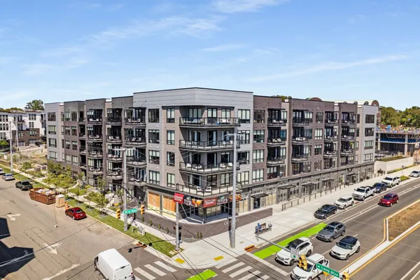 a roof deck with table and chairs and potted plants