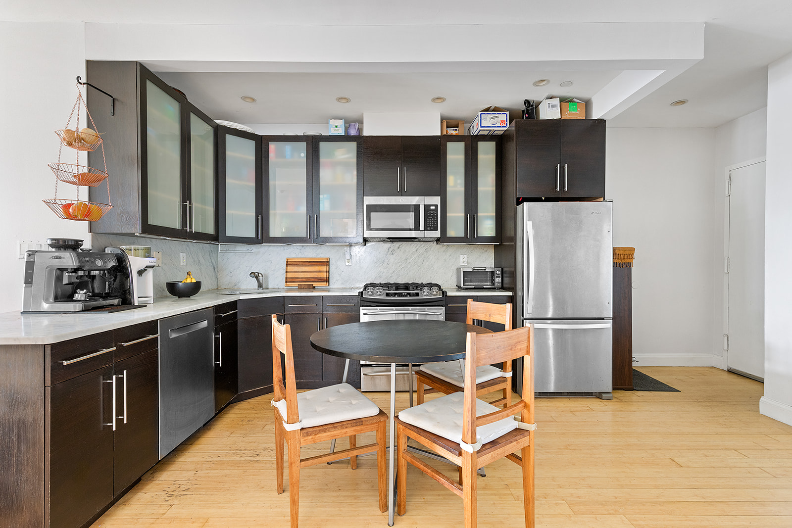 35 McDonald Avenue, Unit 1B Brooklyn, NY 11218 - Photo 2 of 7 a kitchen with stainless steel appliances a refrigerator a stove a sink dishwasher and white cabinets with wooden floor