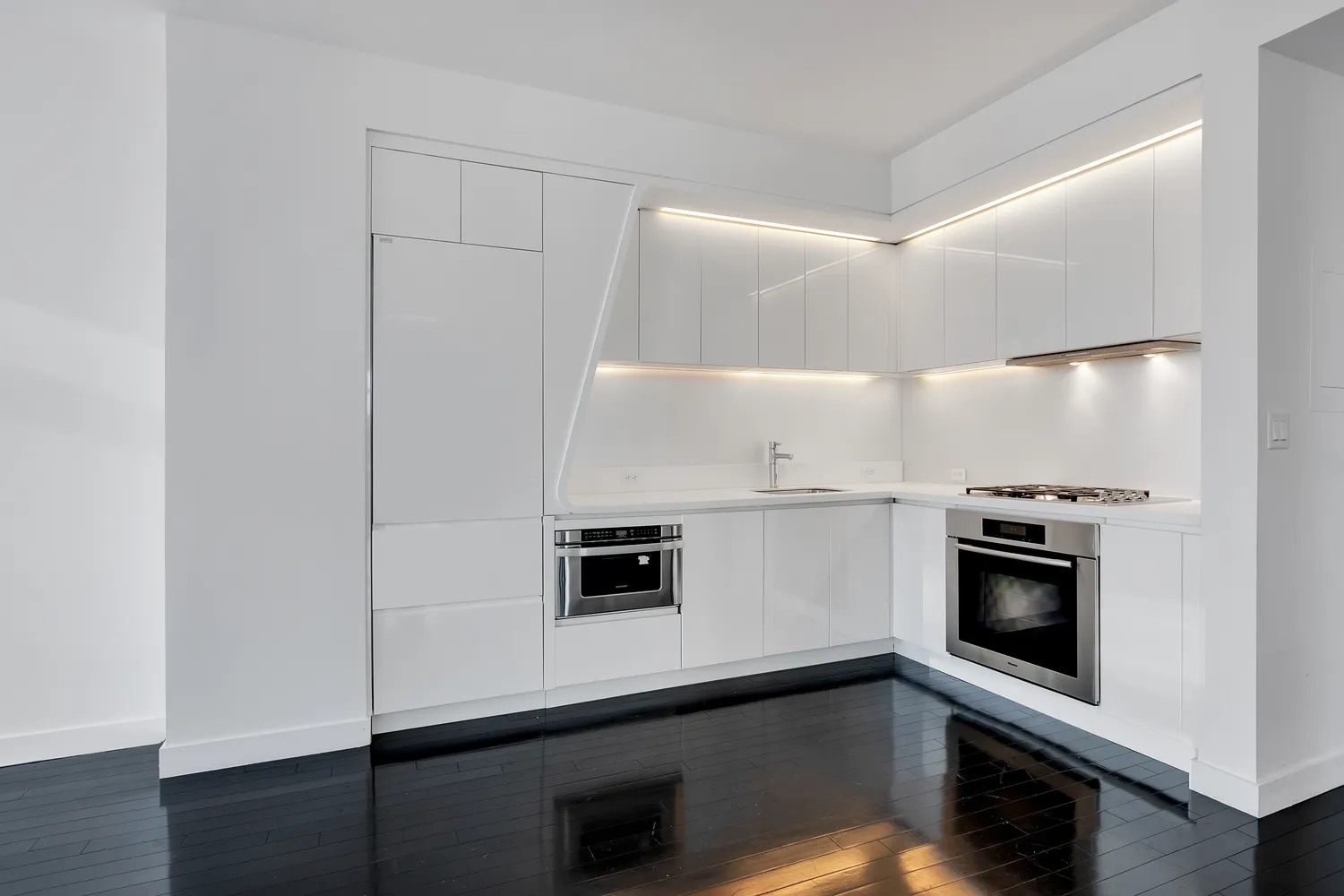 a kitchen with a sink and stainless steel appliances