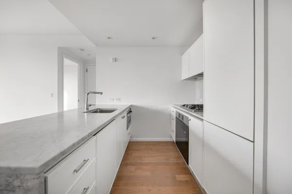 a kitchen with a sink stove and cabinets