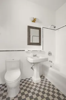 a bathroom with a sink a toilet and mirror