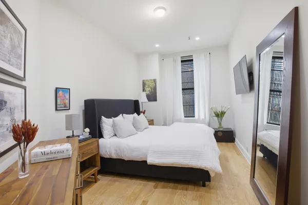 a bedroom with a bed and a couch