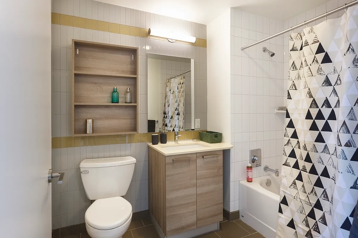 626 Flatbush Avenue, Unit 9H Brooklyn, NY 11225 - Photo 3 of 18 a bathroom with a sink a toilet and shower