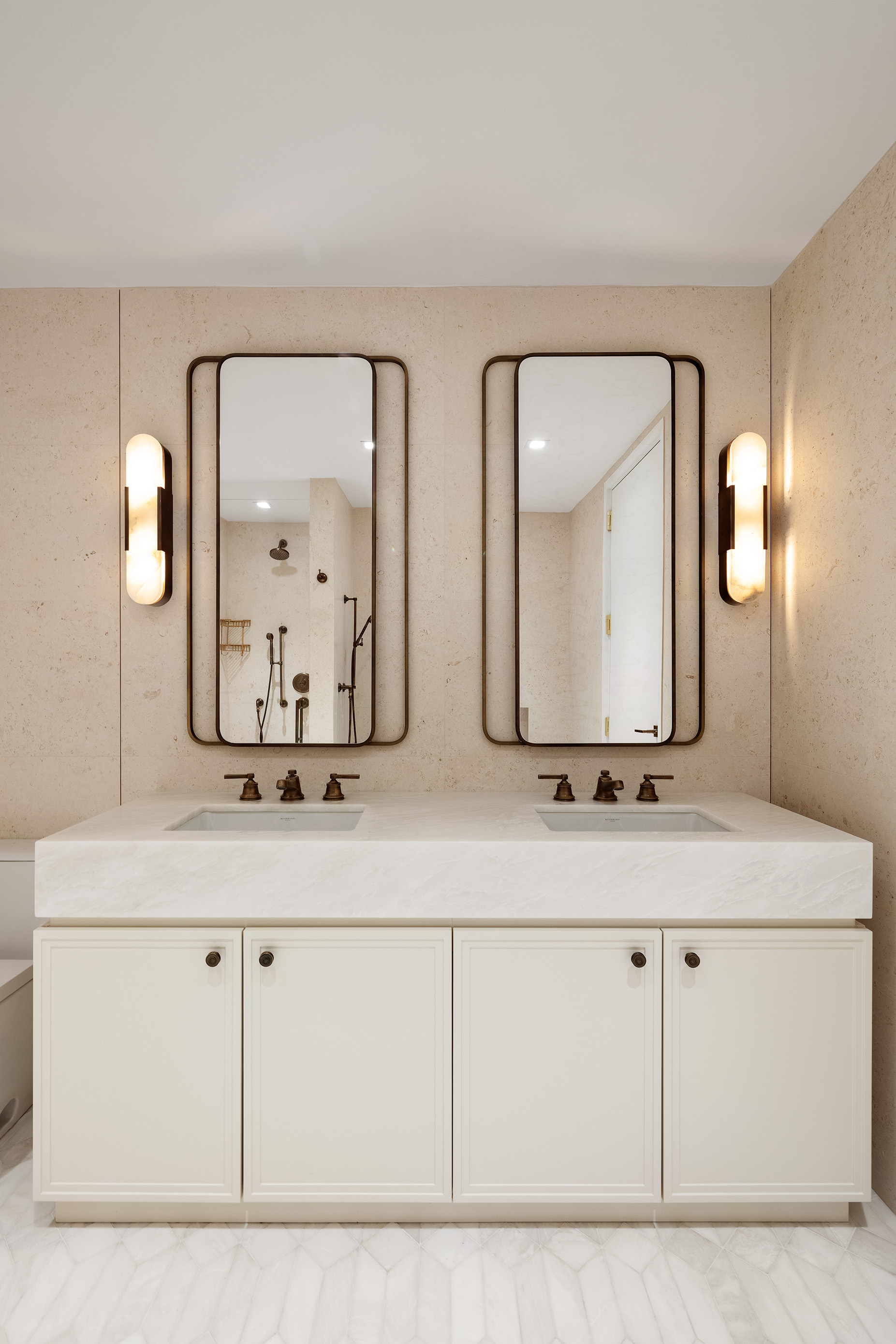 310 East 86th Street, Unit 4B Manhattan, NY 10028 - Photo 11 of 25 a bathroom with double vanity sinks and a mirror