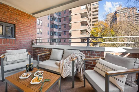 a view of a balcony with furniture and a window