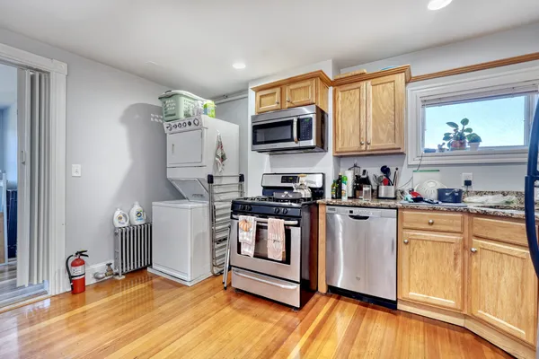 a kitchen with stainless steel appliances granite countertop a stove a sink and a refrigerator