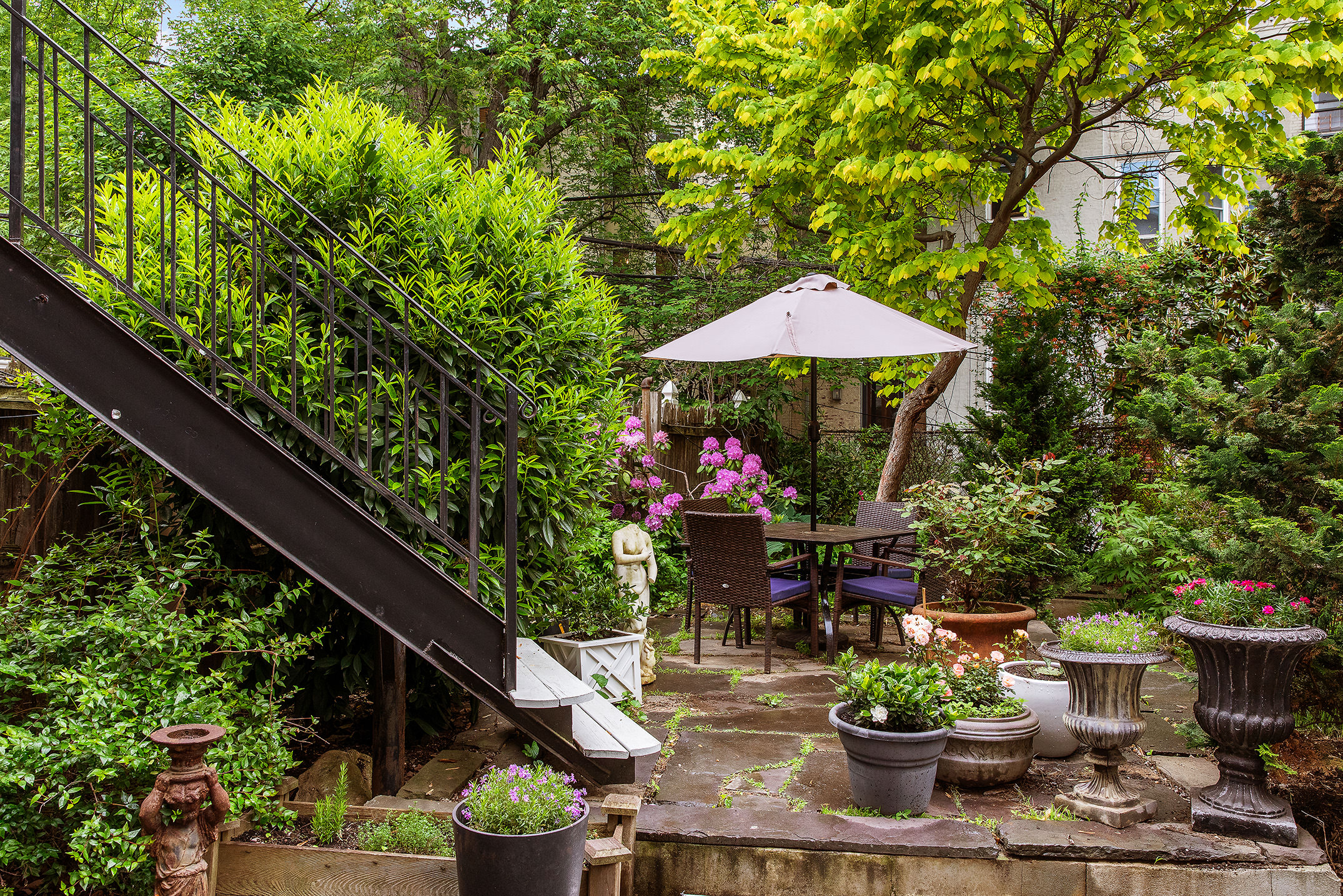 183 Halsey Street Brooklyn, NY 11216 - Photo 8 of 23 a view of a table and chairs under an umbrella
