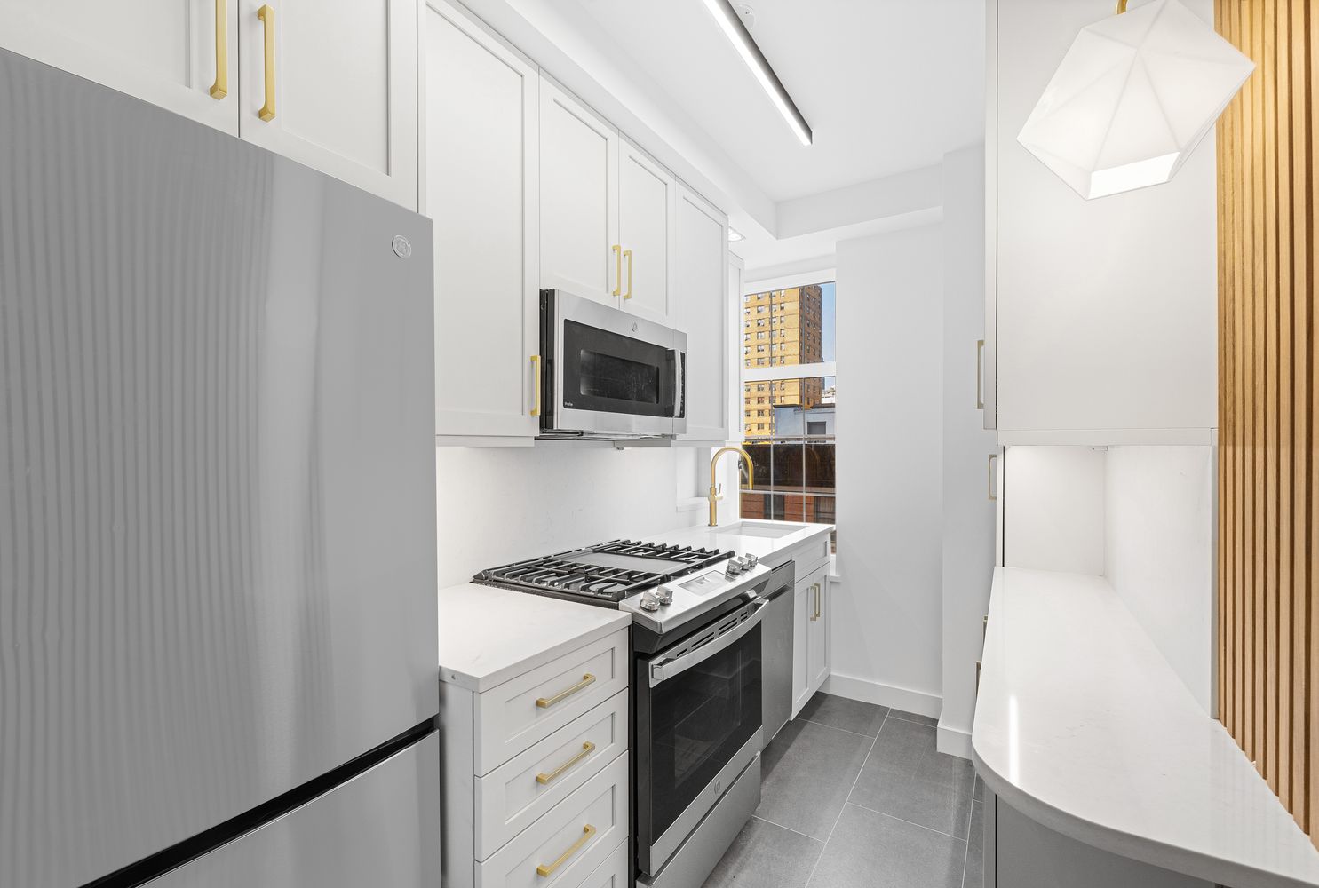 a kitchen with stainless steel appliances a refrigerator and a stove top oven