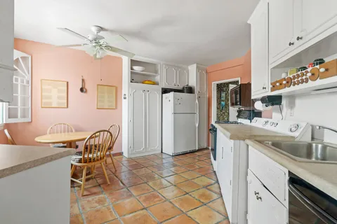 a kitchen with stainless steel appliances granite countertop a sink and a refrigerator