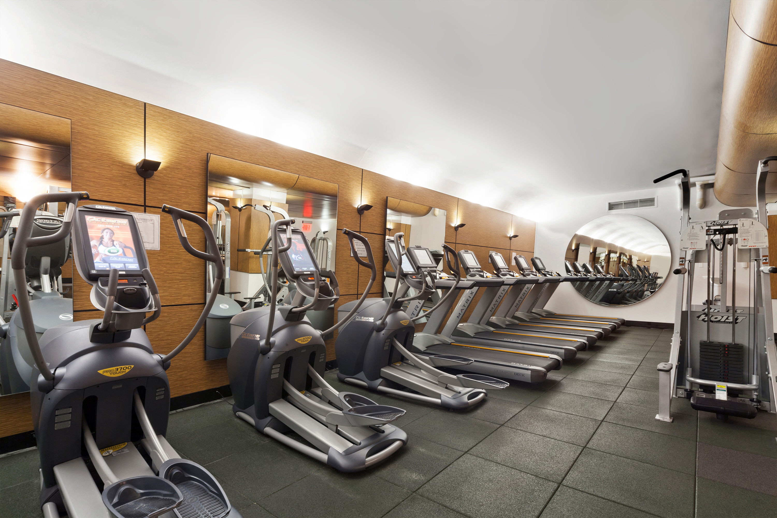 343 East 30th Street, Unit 21G Manhattan, NY 10016 - Photo 9 of 15 a room with gym equipment and mirrors