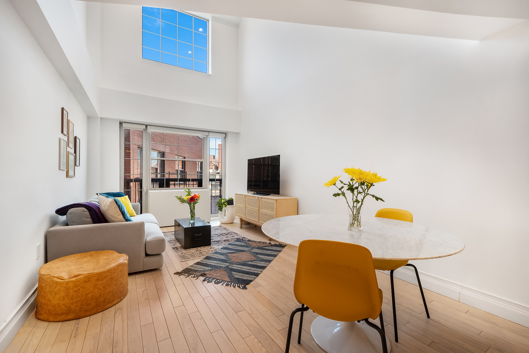 163 St Nicholas Avenue, Unit PH7A Manhattan, NY 10026 - Photo 1 of 11 a living room with furniture and wooden floor