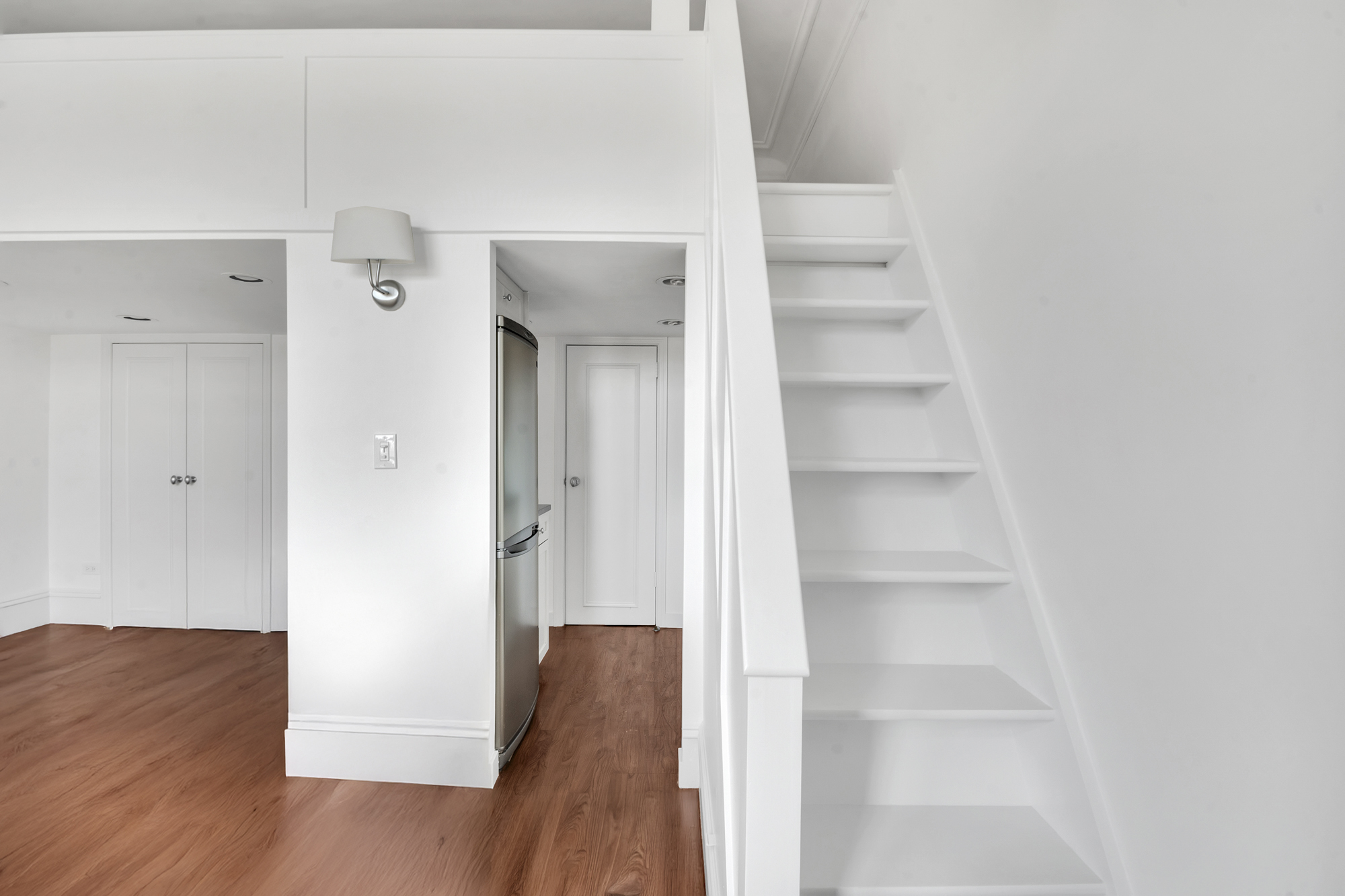 140 West 69th Street, Unit 107A Manhattan, NY 10023 - Photo 12 of 15 a view of a hallway with wooden floor and closet