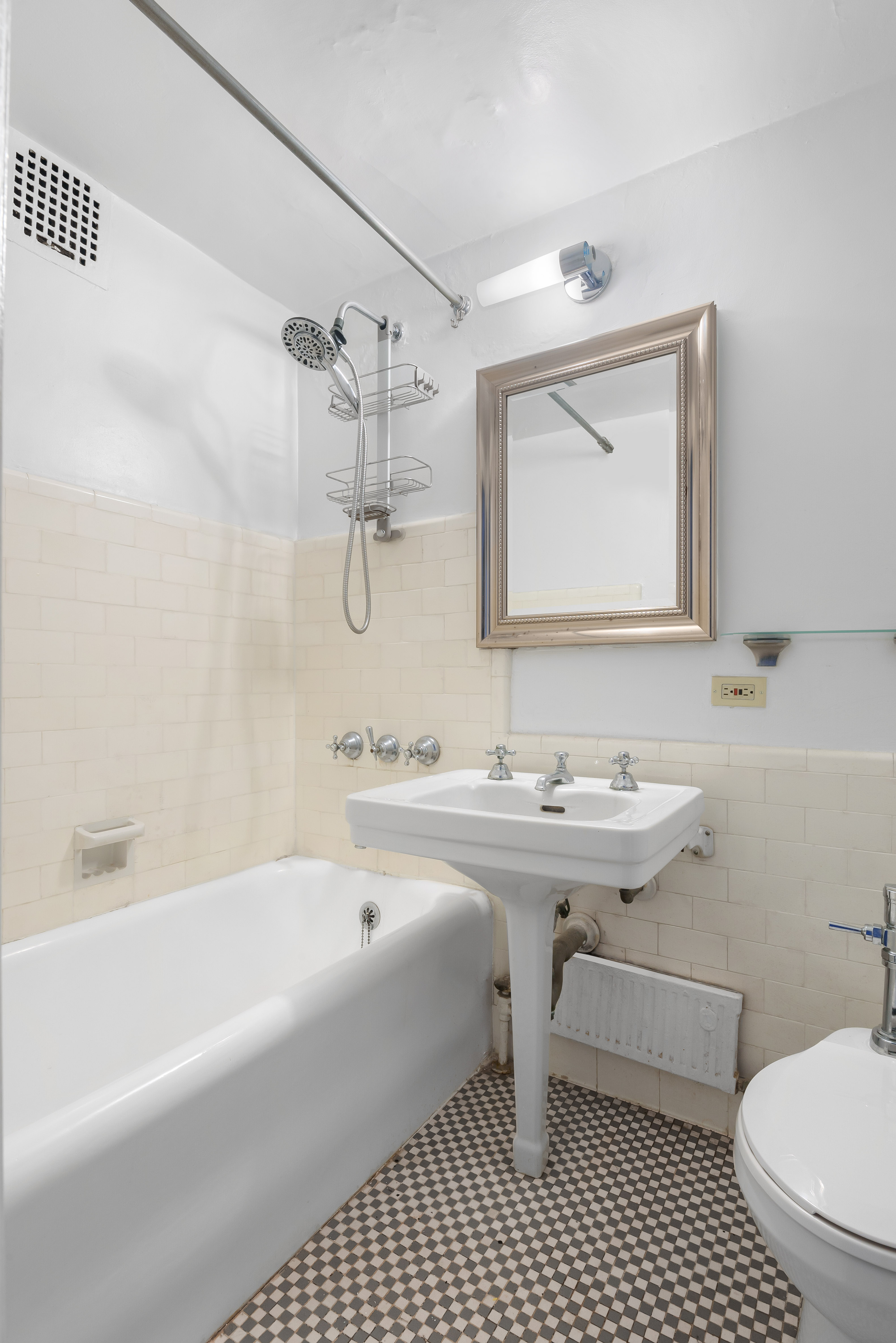 5 Tudor City Place, Unit 1607 Manhattan, NY 10017 - Photo 3 of 5 a bathroom with a sink a toilet and a bathtub