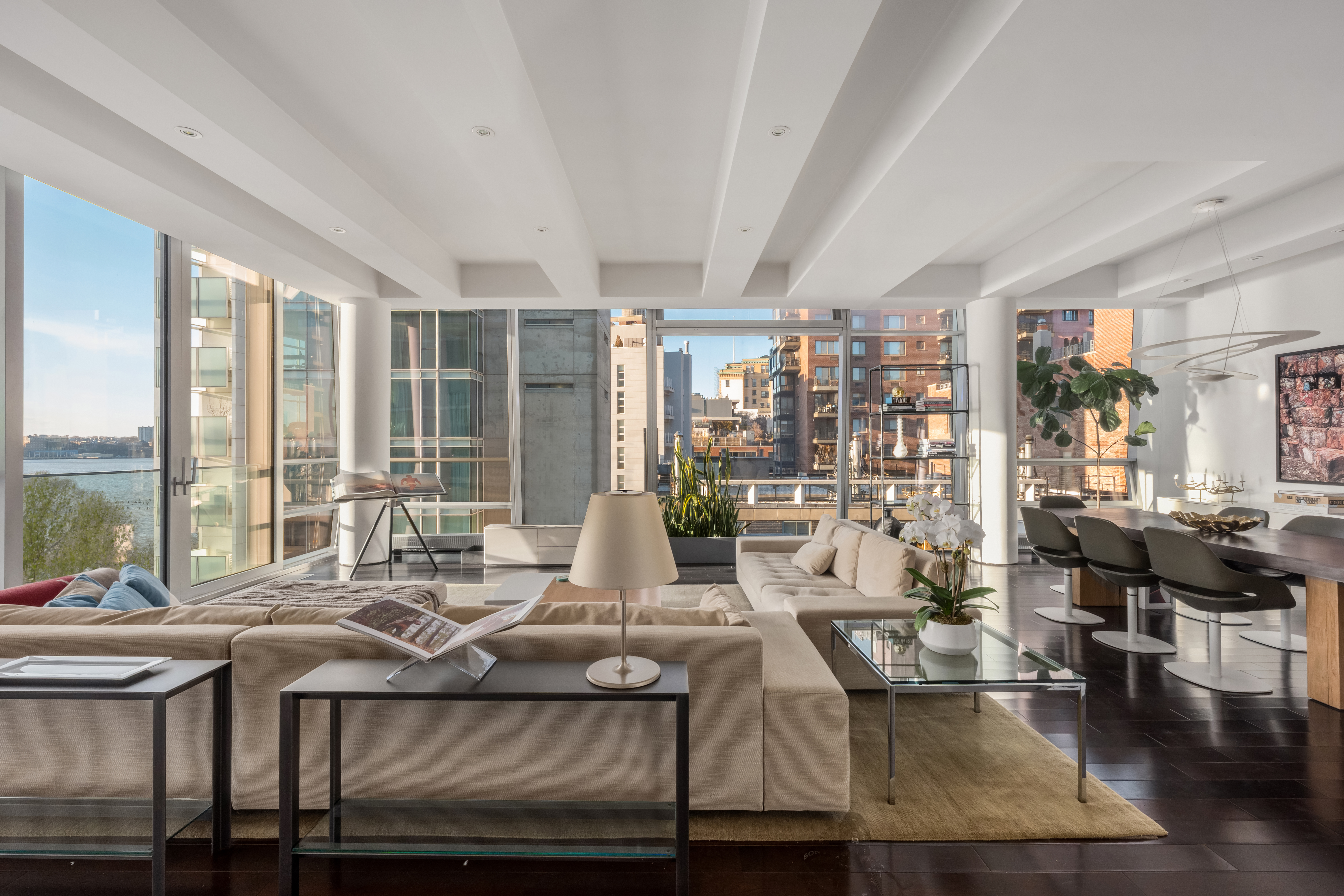 166 Perry Street, Unit 6A Manhattan, NY 10014 - Photo 6 of 20 a view of a living room and kitchen floor to ceiling windows