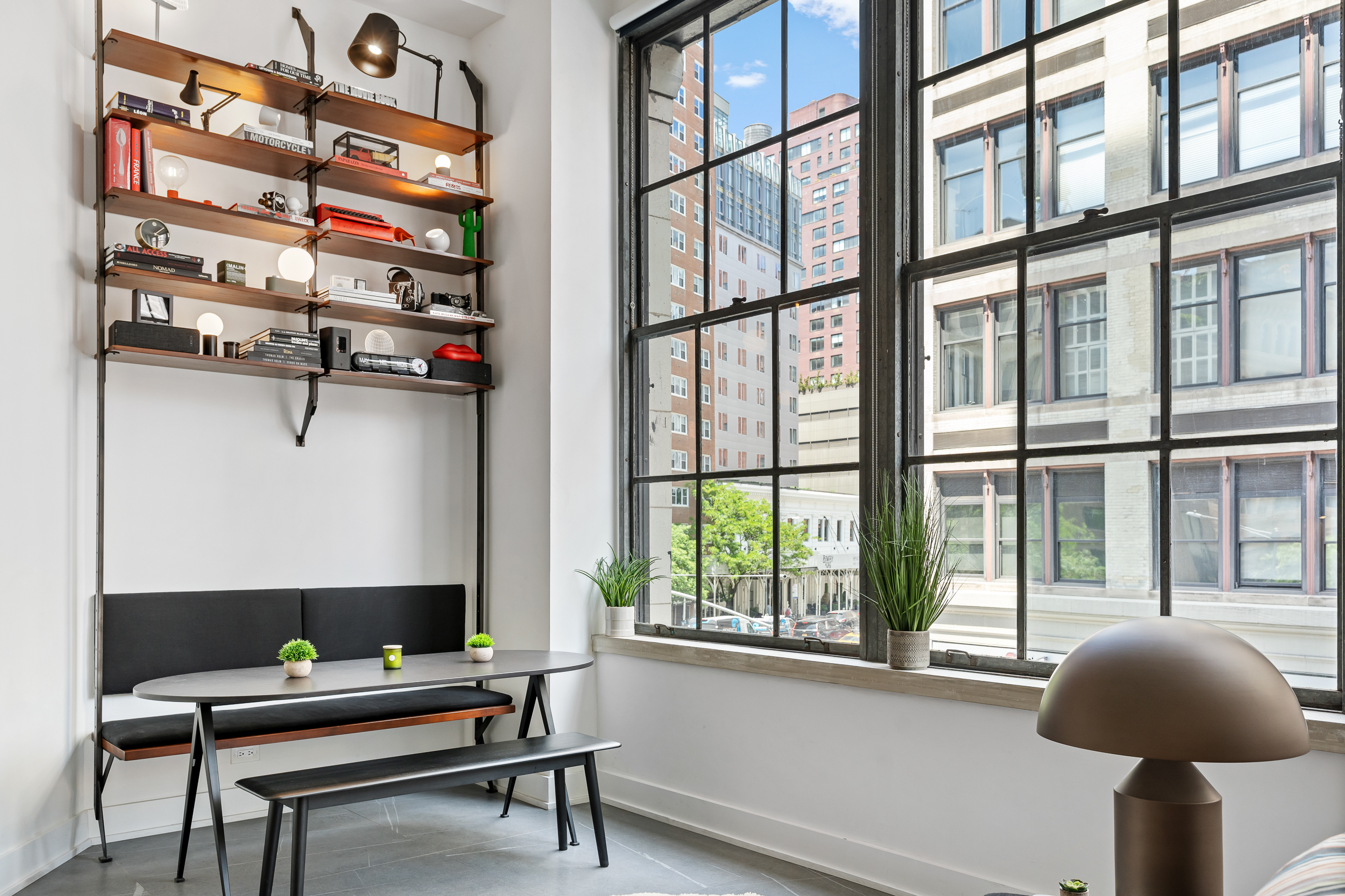 111 4th Avenue, Unit 1J Manhattan, NY 10003 - Photo 4 of 11 a table and chair in a room with a window