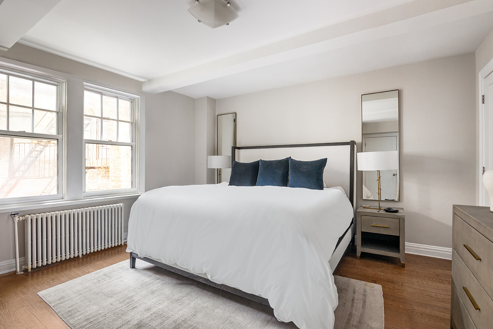 302 West 12th Street, Unit 5G Manhattan, NY 10014 - Photo 7 of 18 a bedroom with a bed and a window with outer view