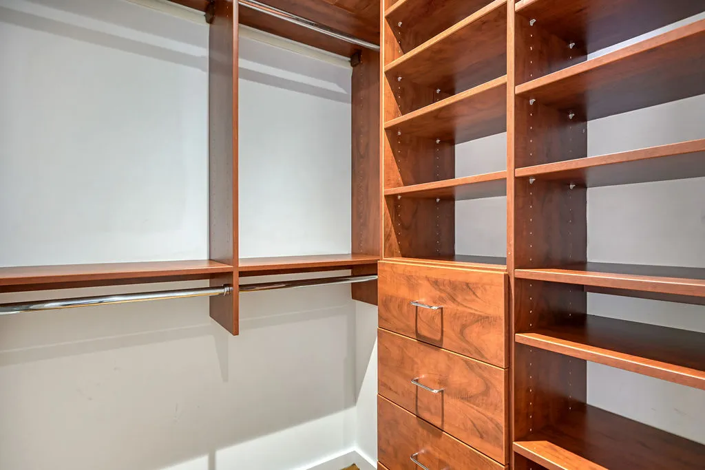 a view of walk in closet with empty racks