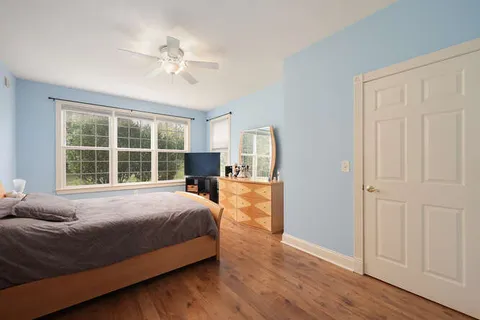 a bedroom with a large bed and a window