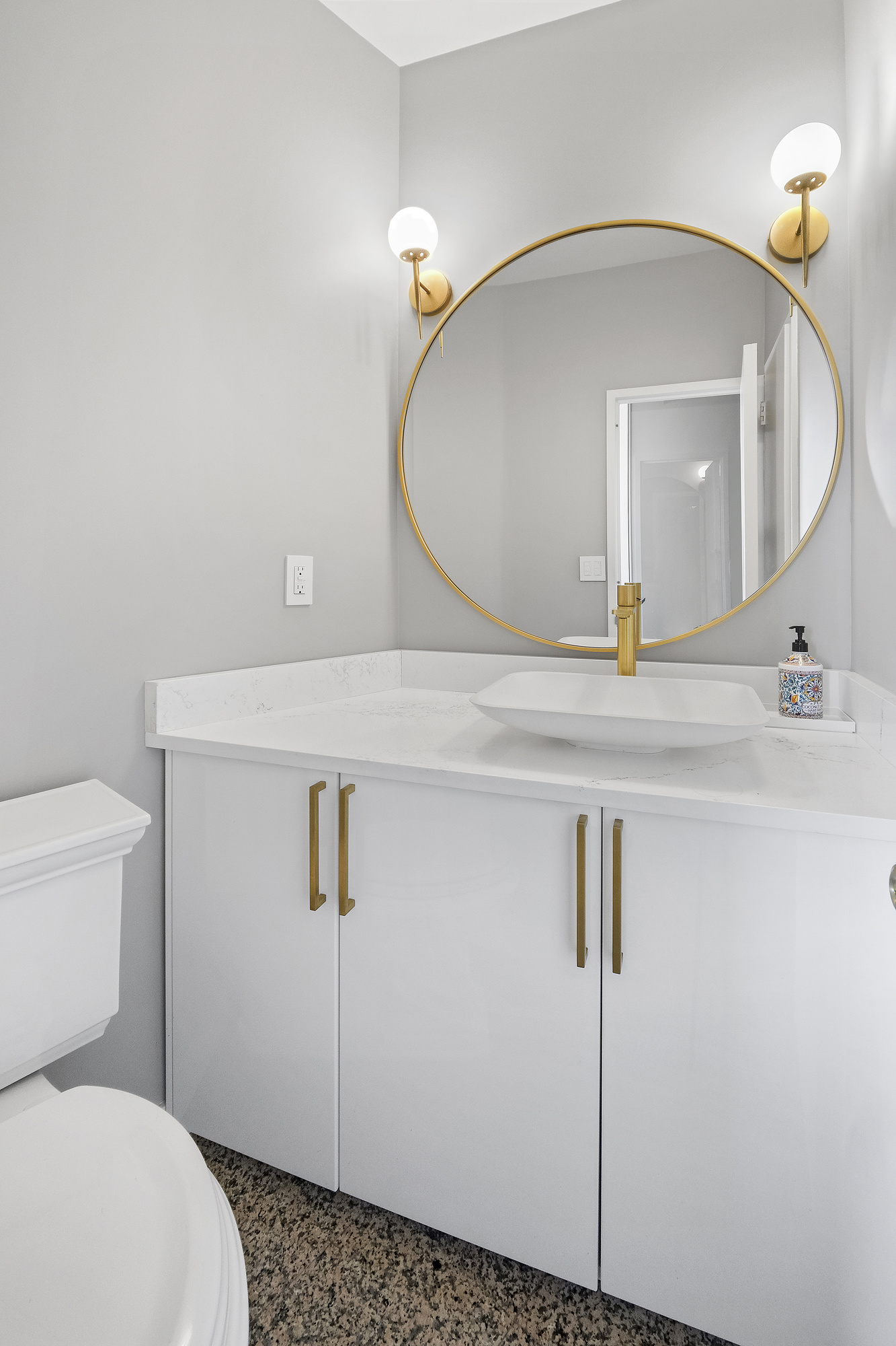 167 East 61st Street, Unit 23D Manhattan, NY 10065 - Photo 4 of 13 a bathroom with a sink a toilet and mirror