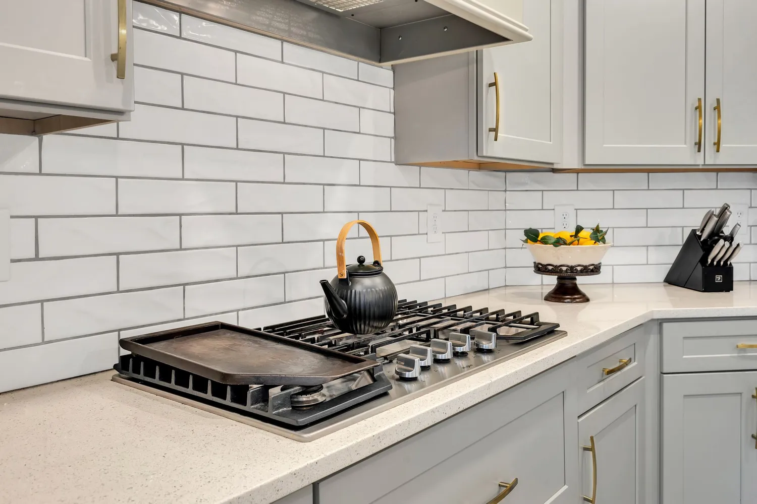 a kitchen with a stove and a cabinets