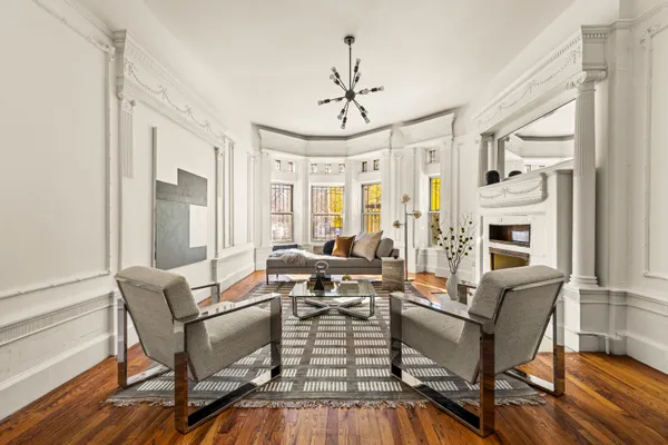 a living room with fireplace furniture and a chandelier