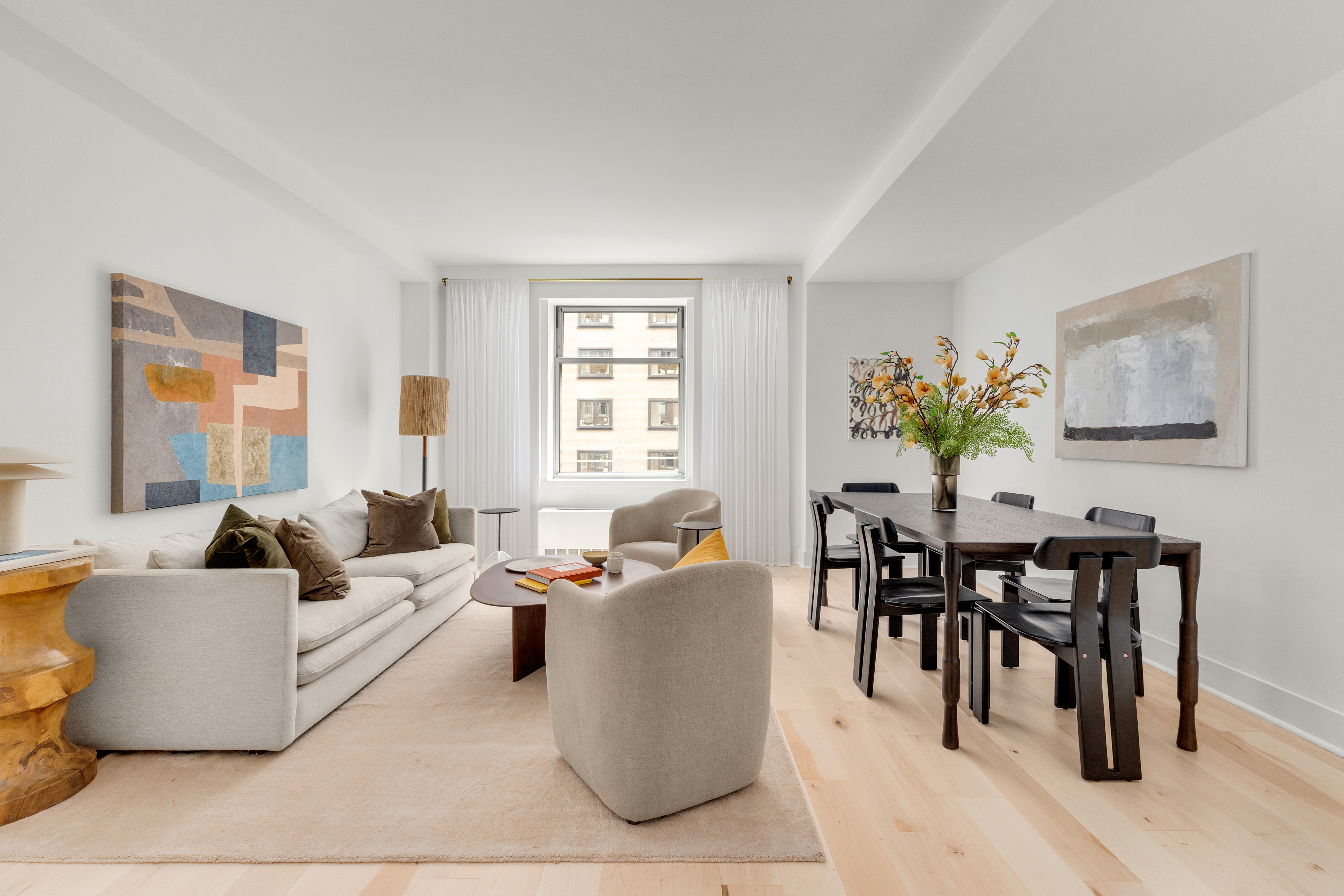 100 West 58th Street, Unit 8C Manhattan, NY 10019 - Photo 1 of 11 a living room with furniture and a large window