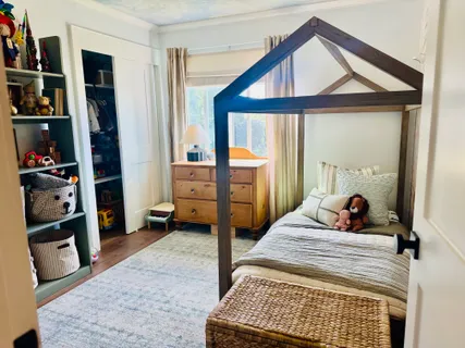 a bedroom with a bed a large mirror and walk in closet