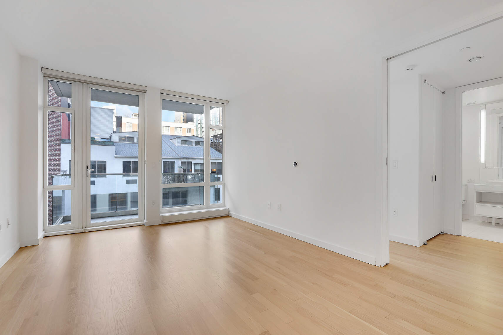 133 West 22nd Street, Unit 7H Manhattan, NY 10011 - Photo 2 of 21 a view of a big room with wooden floor and windows