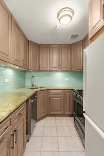 a kitchen with granite countertop stainless steel appliances and cabinets