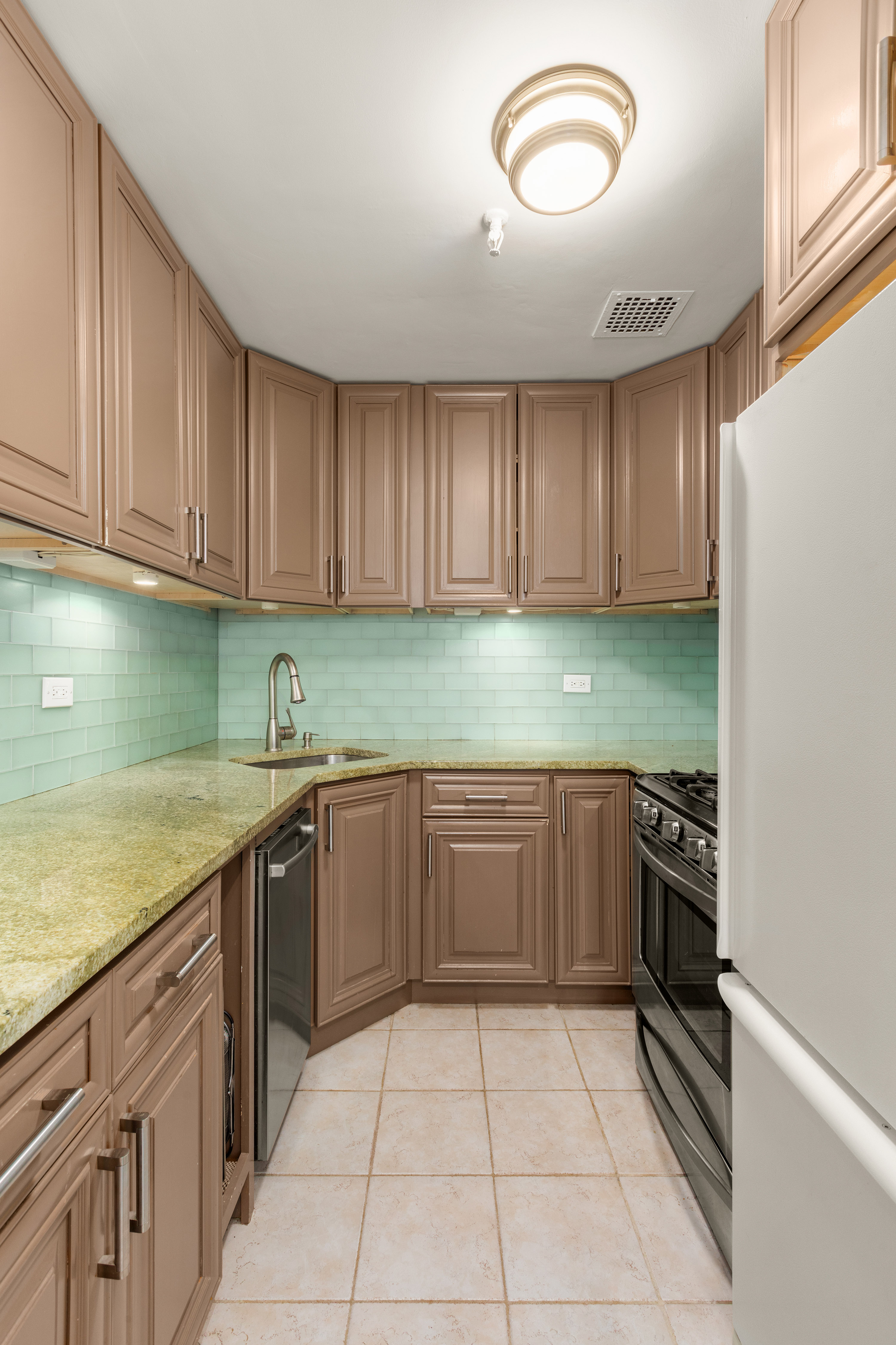 111 East 36th Street, Unit 4A Manhattan, NY 10016 - Photo 8 of 19 a kitchen with granite countertop stainless steel appliances and cabinets