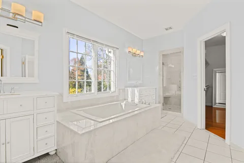 a bathroom with a granite countertop sink mirror and a toilet