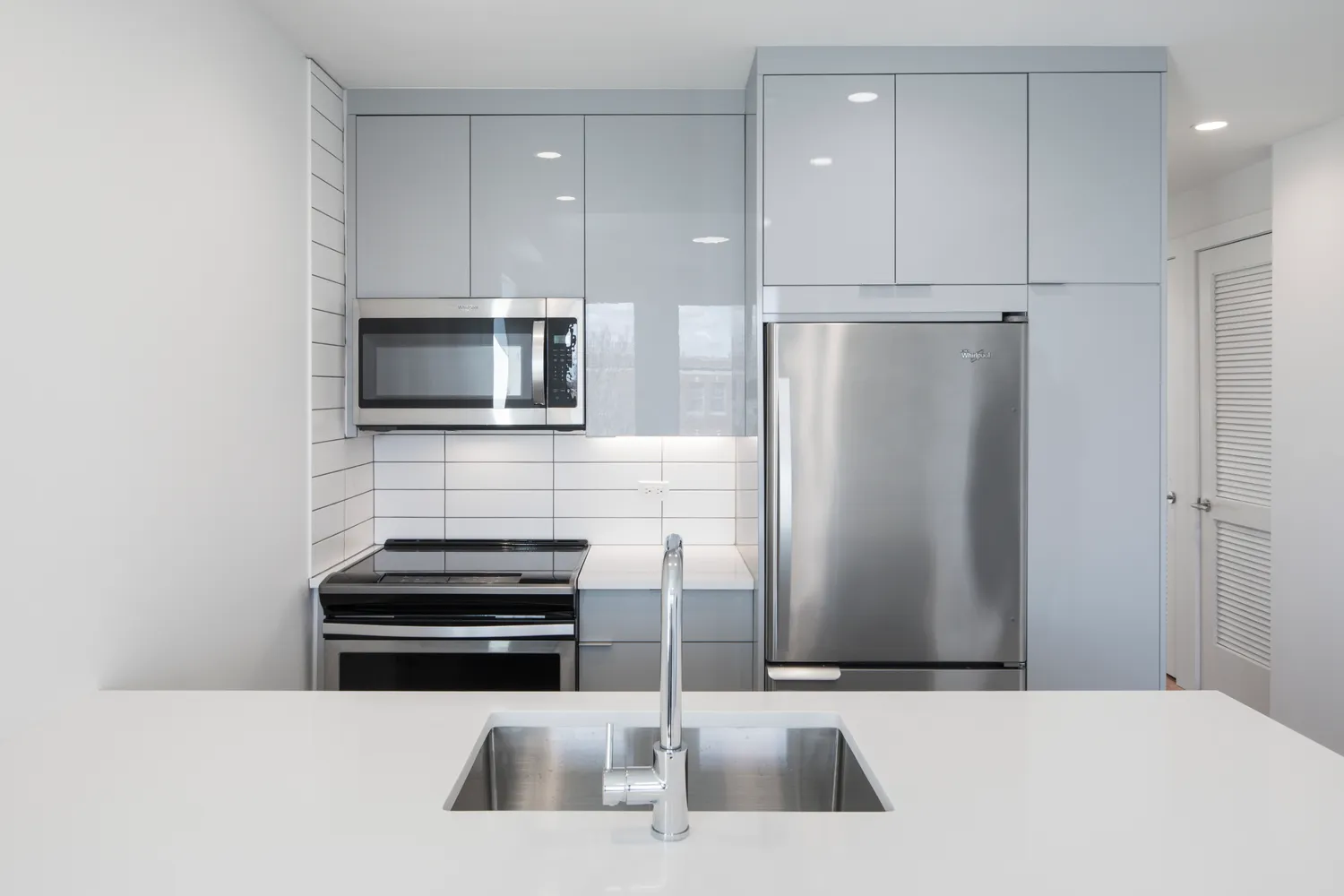 a kitchen with stainless steel appliances a refrigerator and a microwave