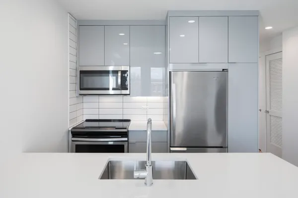 a kitchen with stainless steel appliances a refrigerator and a microwave