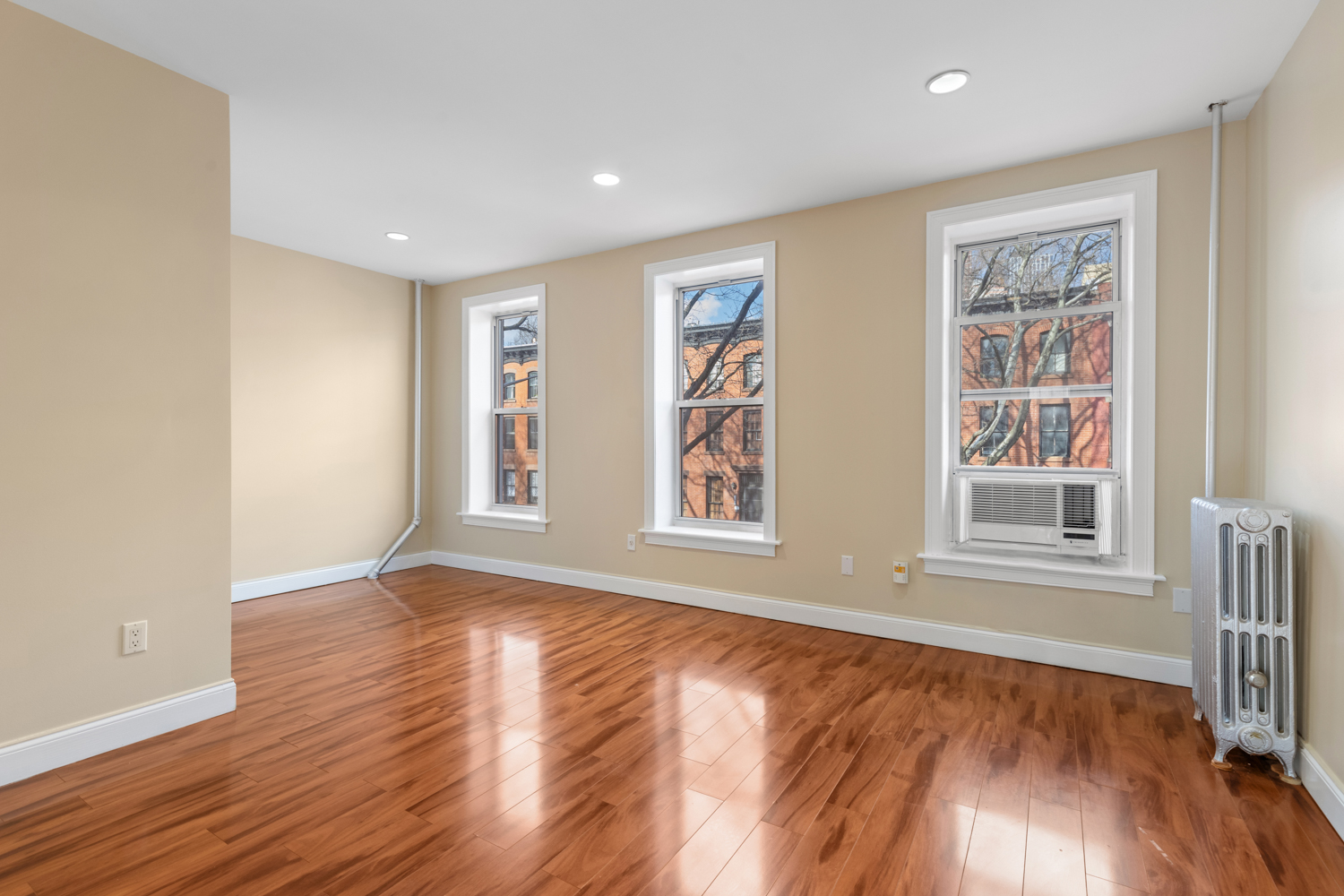 176 Bergen Street, Unit 2 Brooklyn, NY 11217 - Photo 3 of 4 a view of an empty room with wooden floor and a window