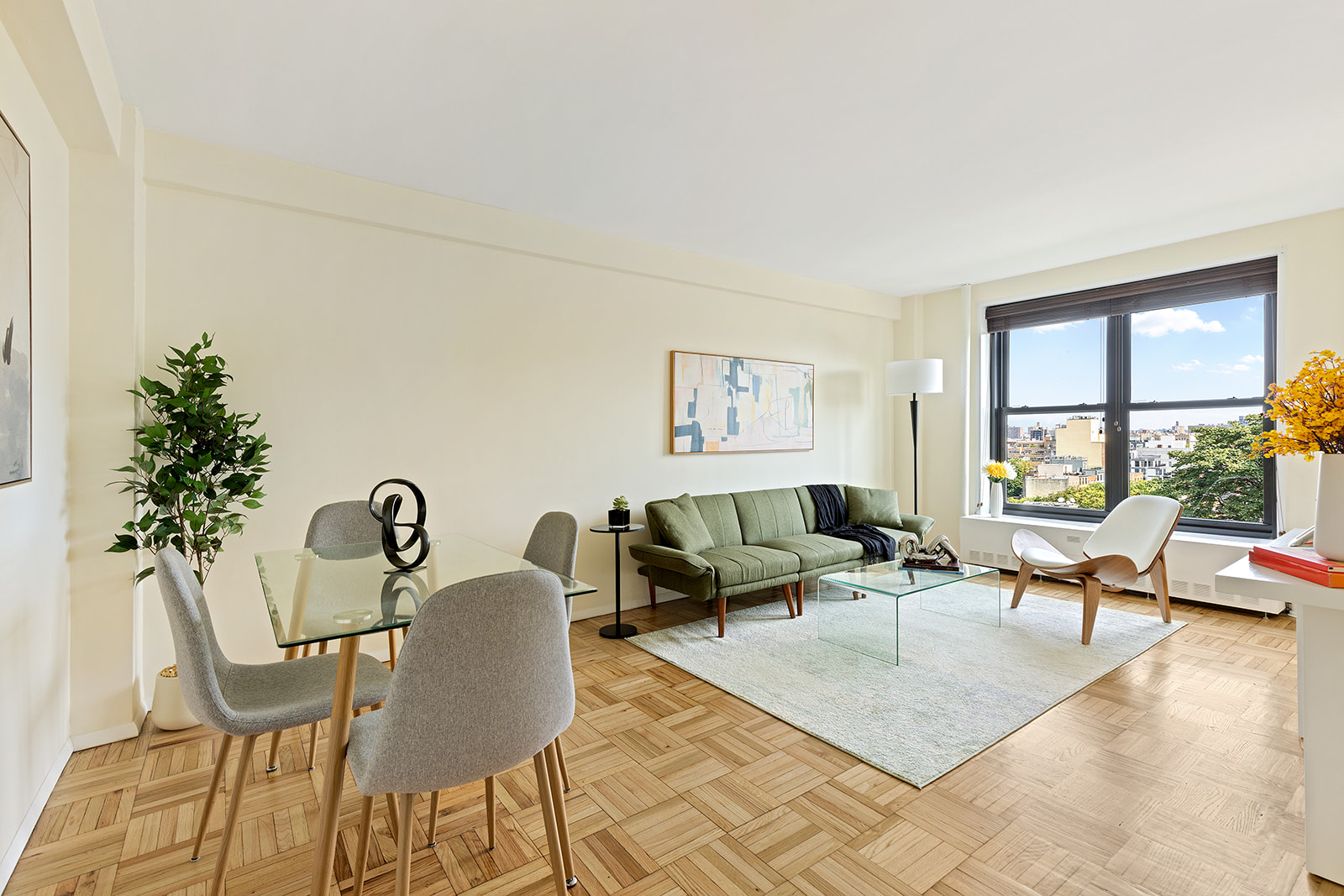 193 Clinton Avenue, Unit 9E Brooklyn, NY 11205 - Photo 2 of 9 a living room with furniture and a potted plant