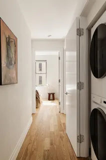 a view of a bedroom with wooden floor and furniture