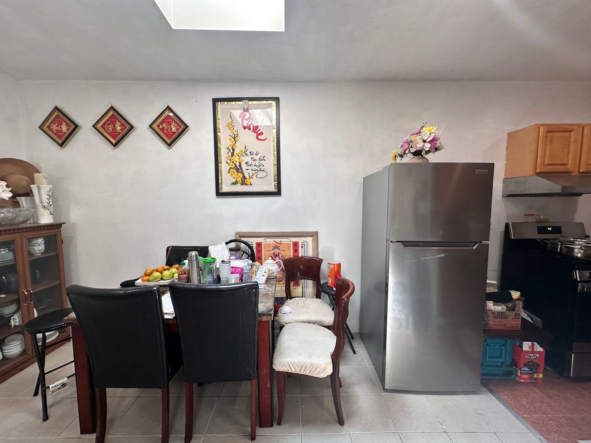 41-34 39th Street Queens, NY 11101 - Photo 4 of 10 a dining room with furniture a refrigerator and a kitchen