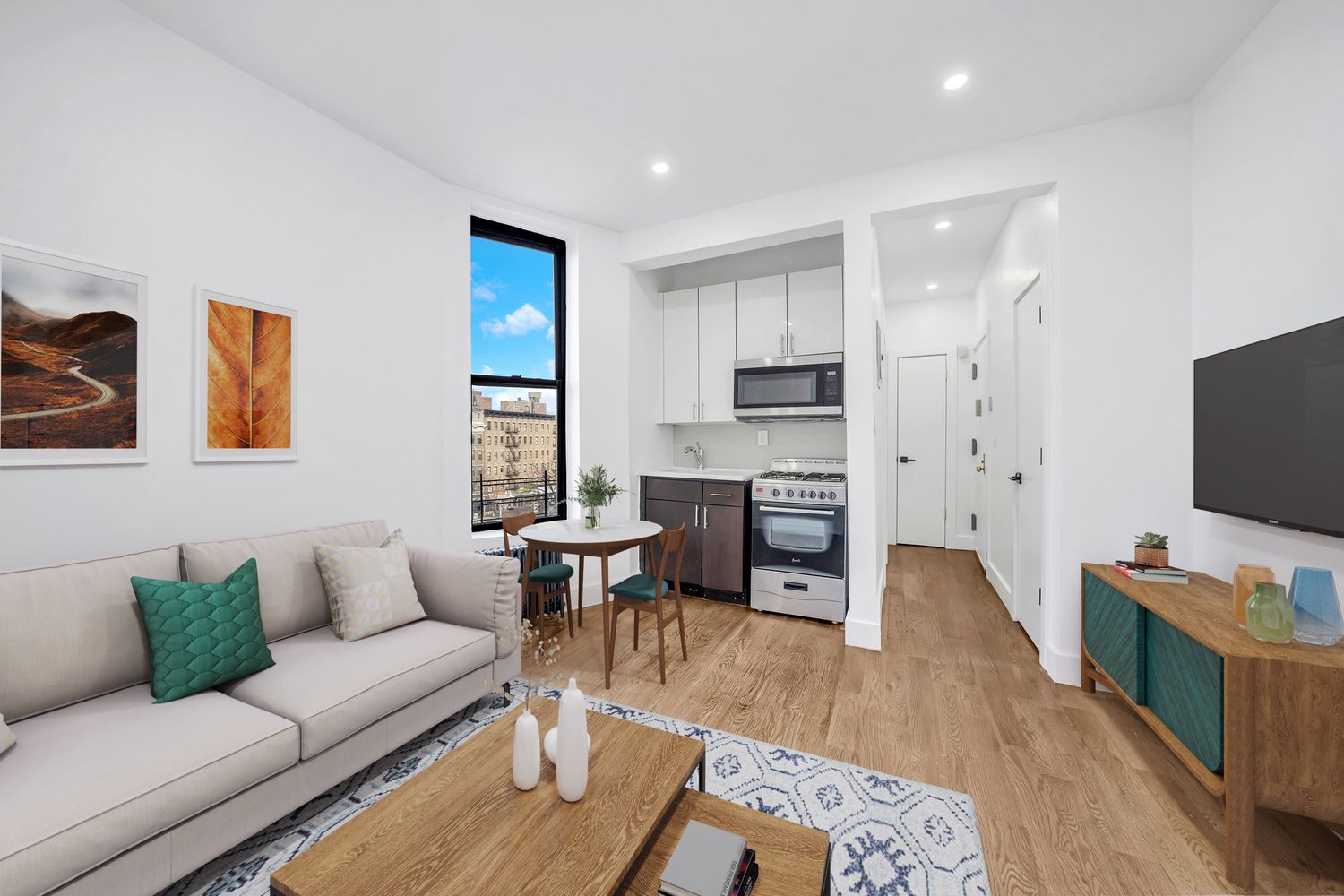 66 West 138th Street, Unit 2D Manhattan, NY 10037 - Photo 1 of 5 a living room with furniture and a flat screen tv