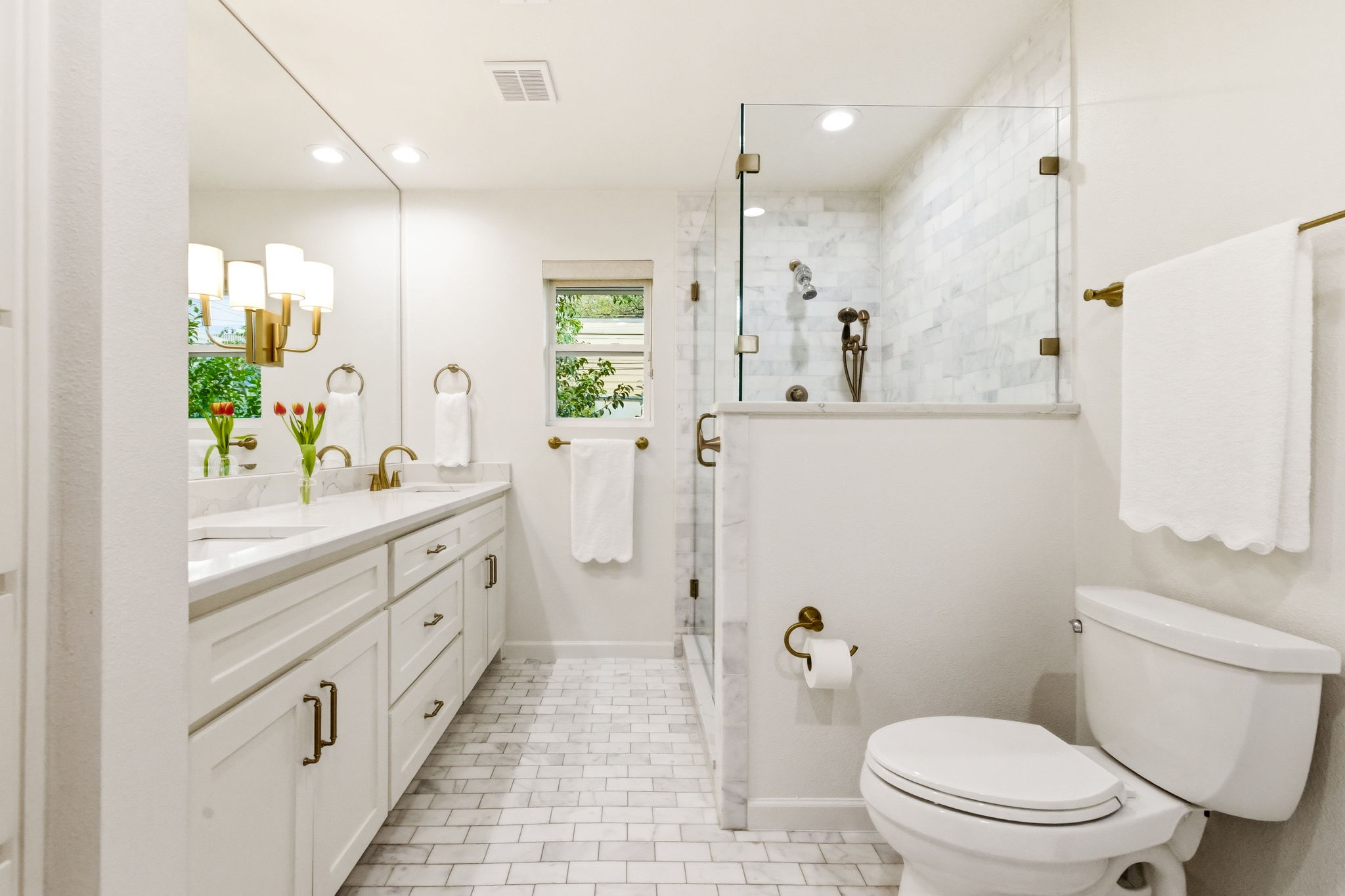 5765 Stonegate Road Dallas, TX 75209 - Photo 23 of 37 a bathroom with a double vanity sink toilet and shower