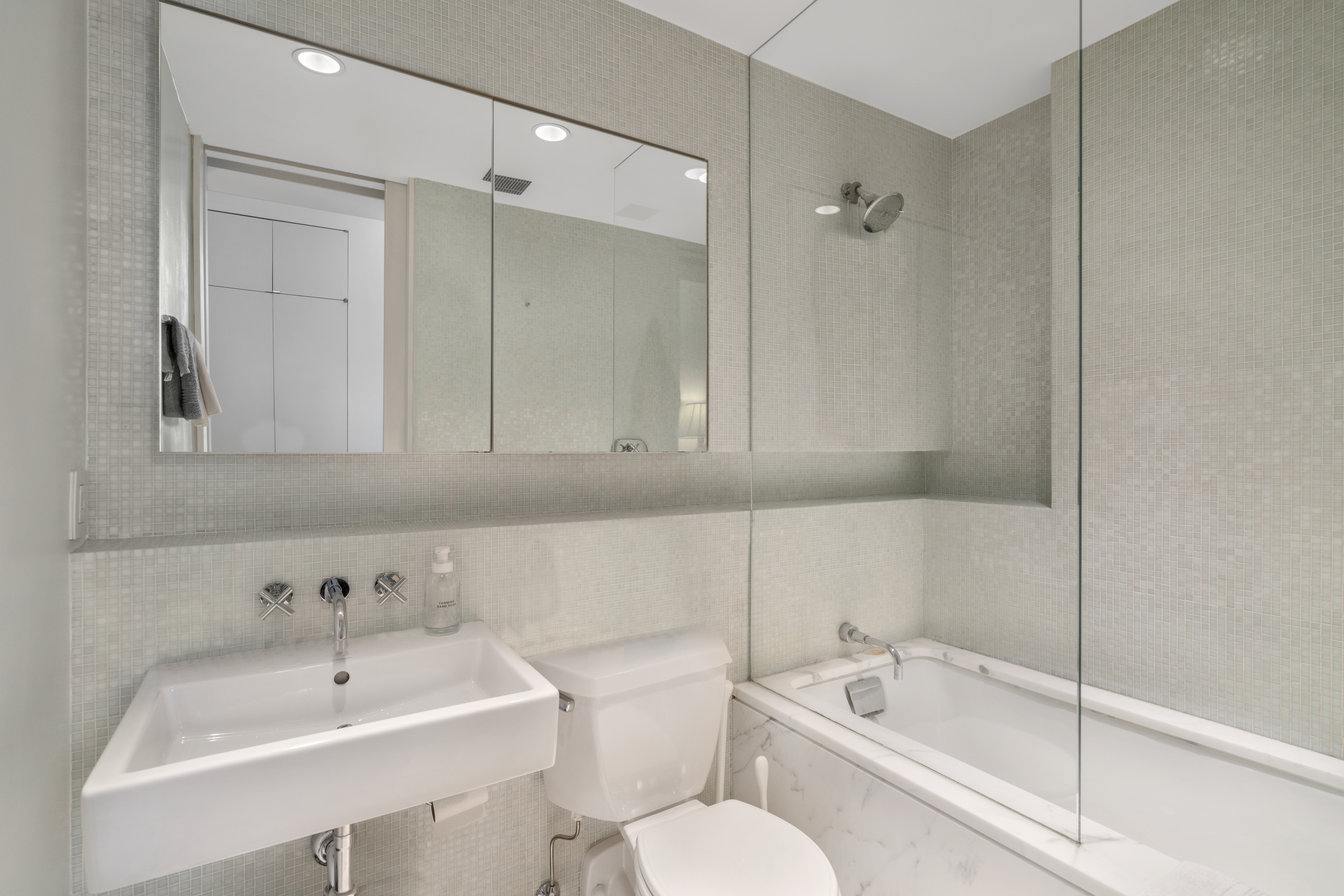 312 East 23rd Street, Unit 7B Manhattan, NY 10010 - Photo 10 of 14 a bathroom with a bathtub shower sink and toilet