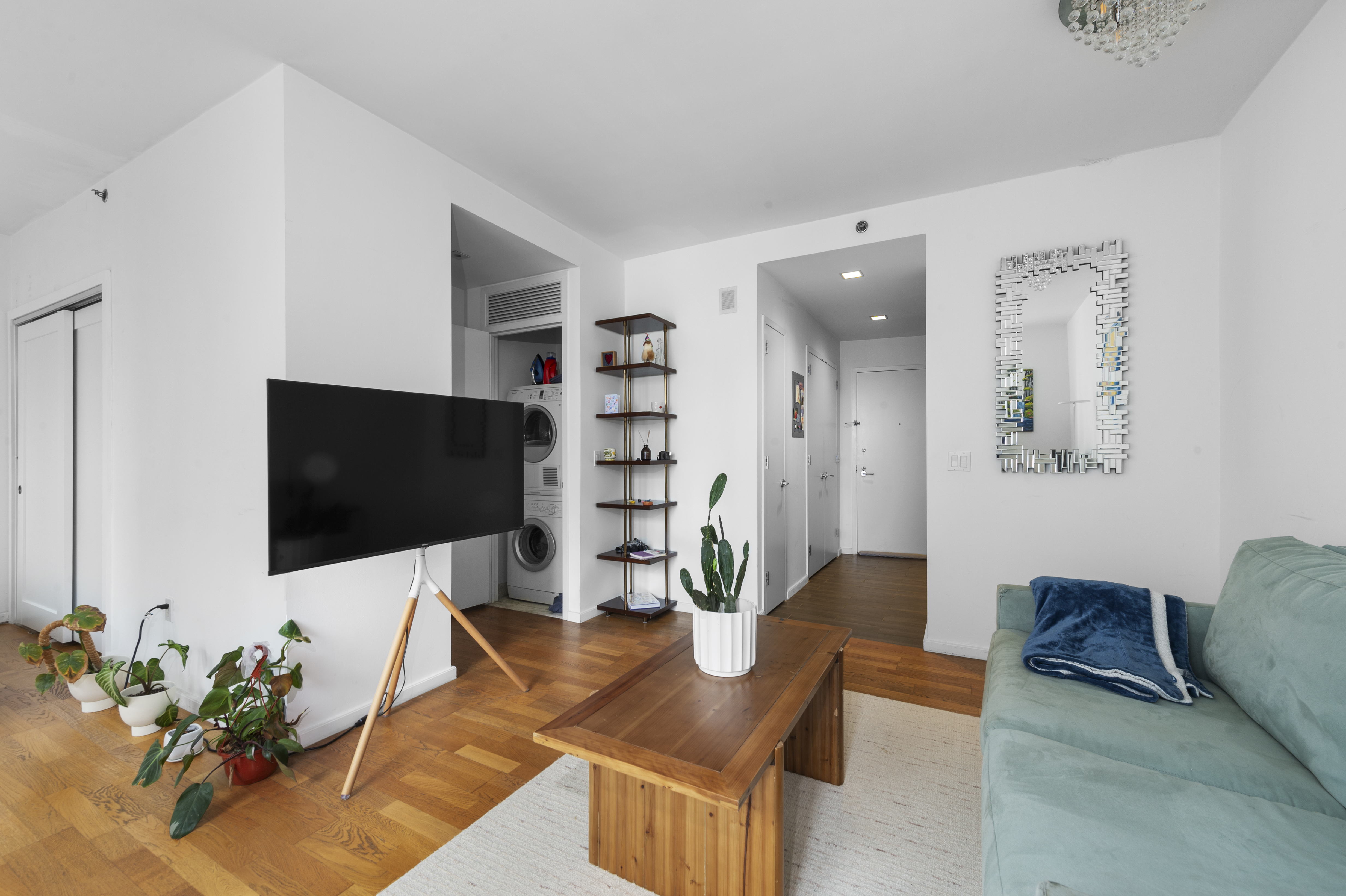 635 West 42nd Street, Unit 14K Manhattan, NY 10036 - Photo 7 of 19 a living room with furniture and a flat screen tv