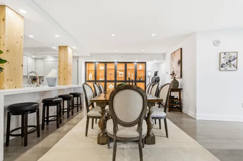 a dining room with furniture a window and wooden floor