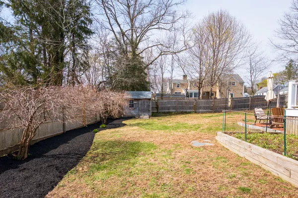 a view of a house with a yard patio and fire pit